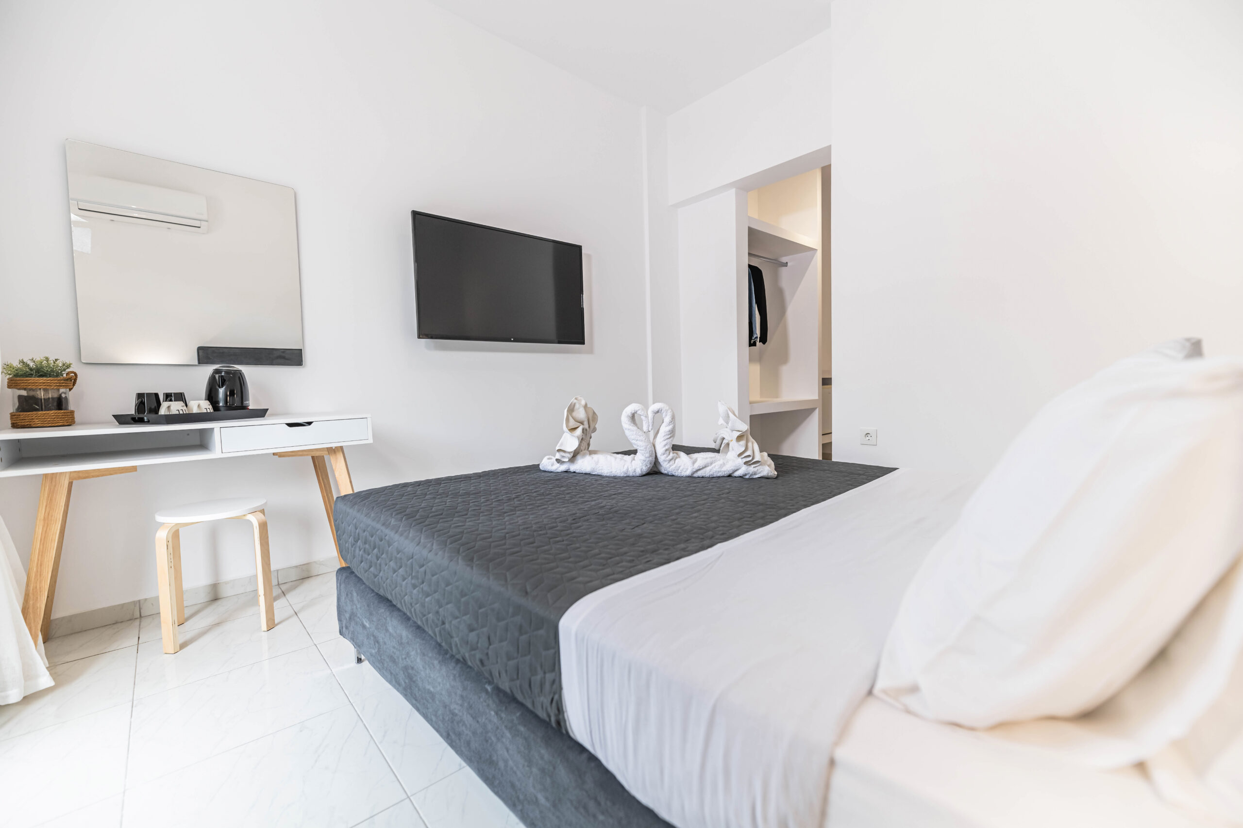 Standard Double/Triple room at Pefkos Breeze hotel with comfortable beds and bright, modern decor.
