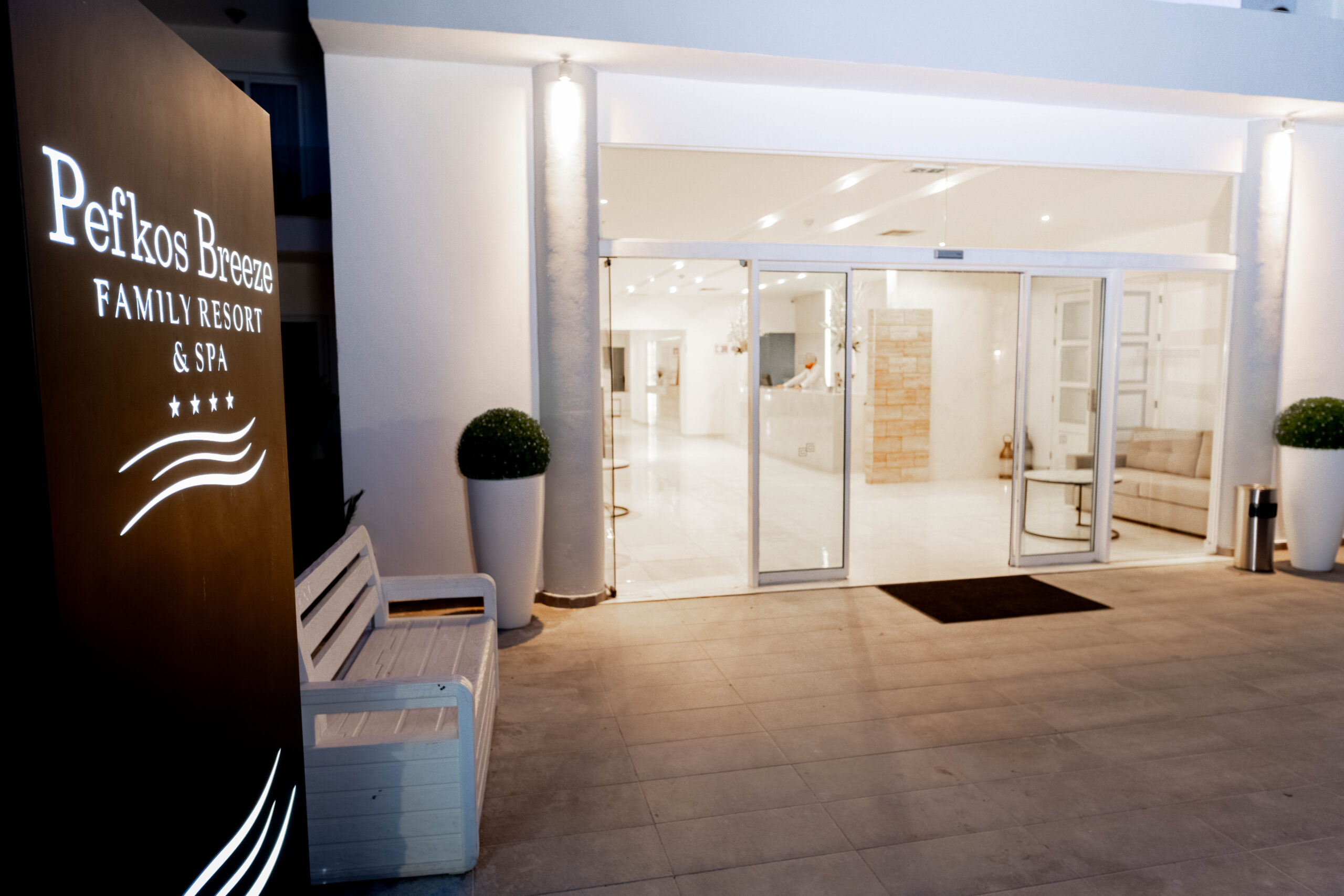 Entrance of Pefkos Breeze hotel, with welcoming architecture and a serene ambiance.